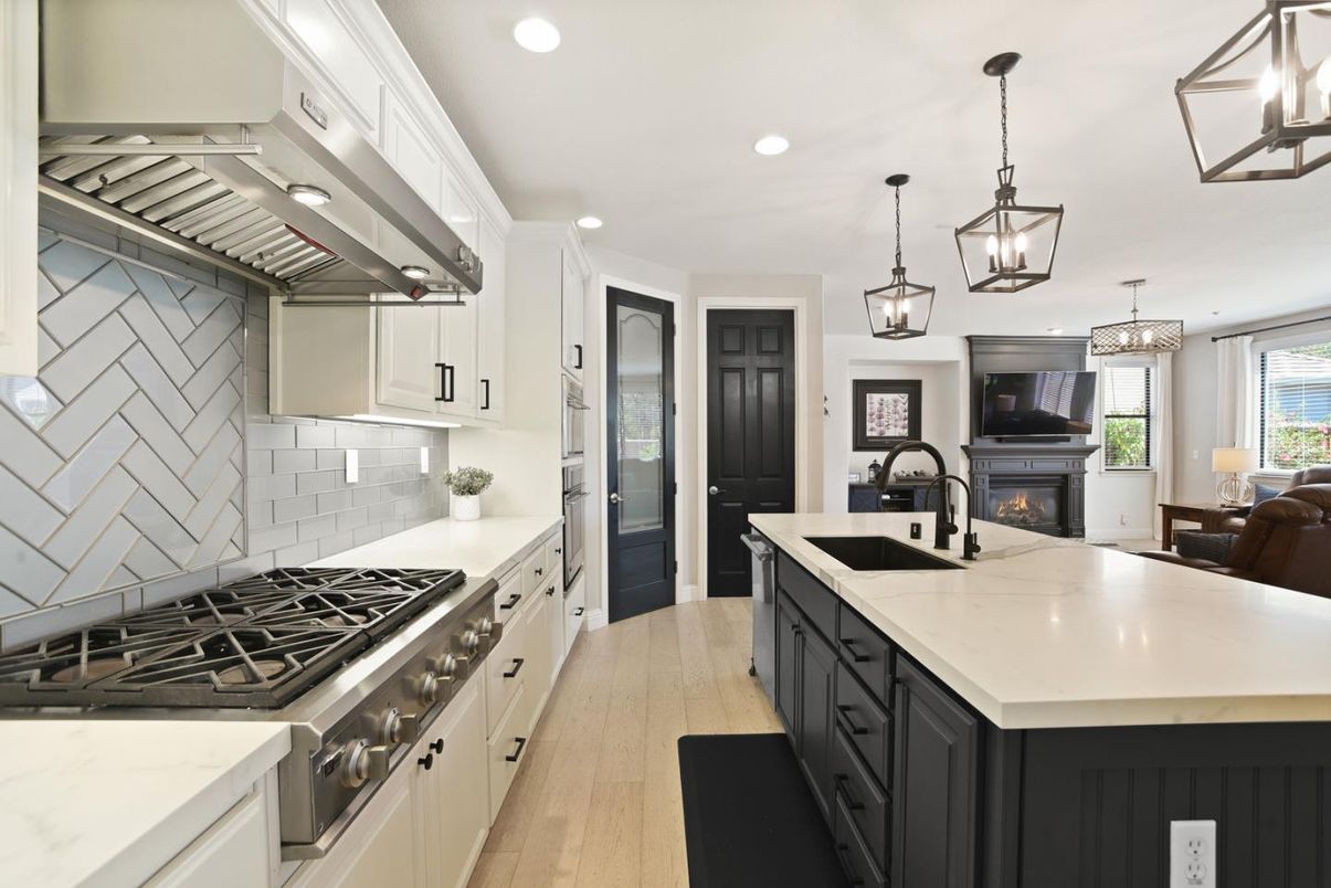 Chandelier, Fireplace, Interior, Kitchen, Pendant Lights, Recessed Lighting, Stainless Steel Appliances, Wood Texture Flooring