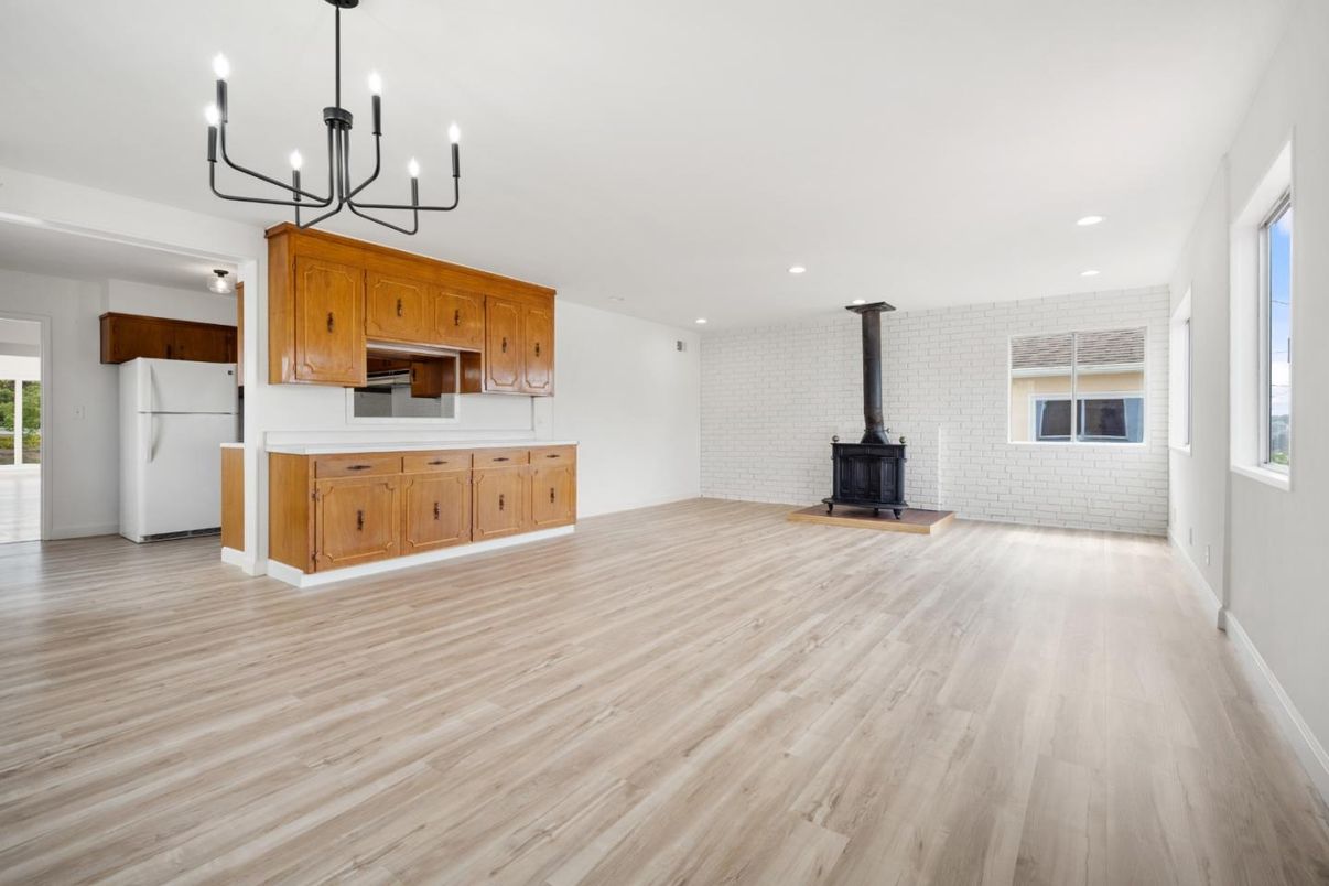 Chandelier, Empty room, Fireplace, Interior, Kitchen, Recessed Lighting, Stone Walls, Wood Texture Flooring