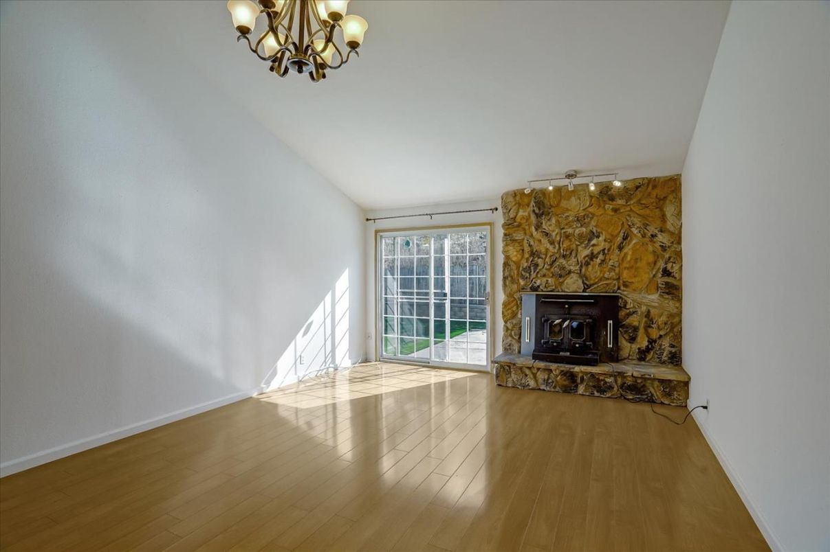 Chandelier, Empty room, Fireplace, Interior, Stone Walls, Wood Texture Flooring