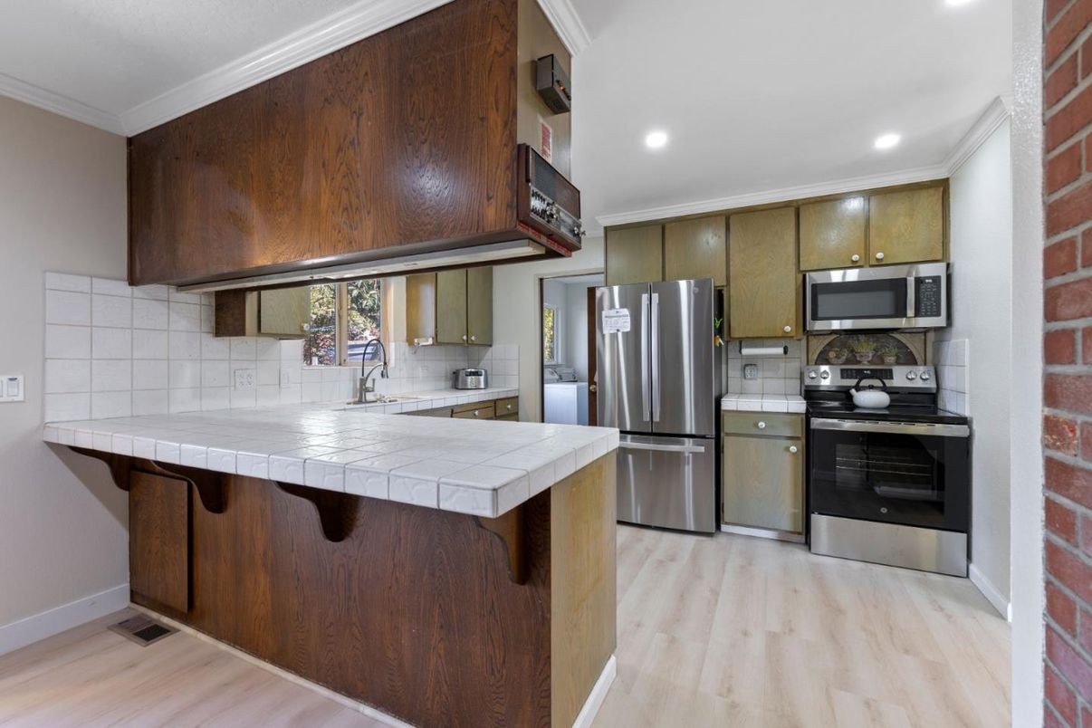 Interior, Kitchen, Recessed Lighting, Stainless Steel Appliances, Tile Countertops, Wood Texture Flooring