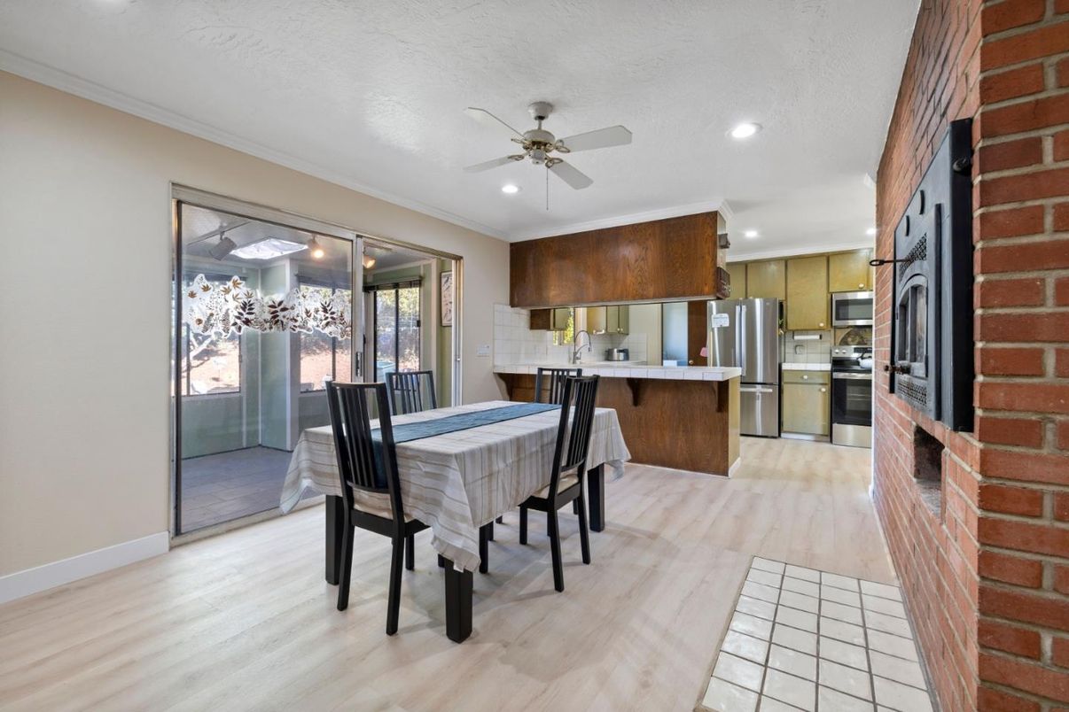 Dining room, Fireplace, Interior, Kitchen, Recessed Lighting, Stainless Steel Appliances, Stone Walls, Wood Texture Flooring