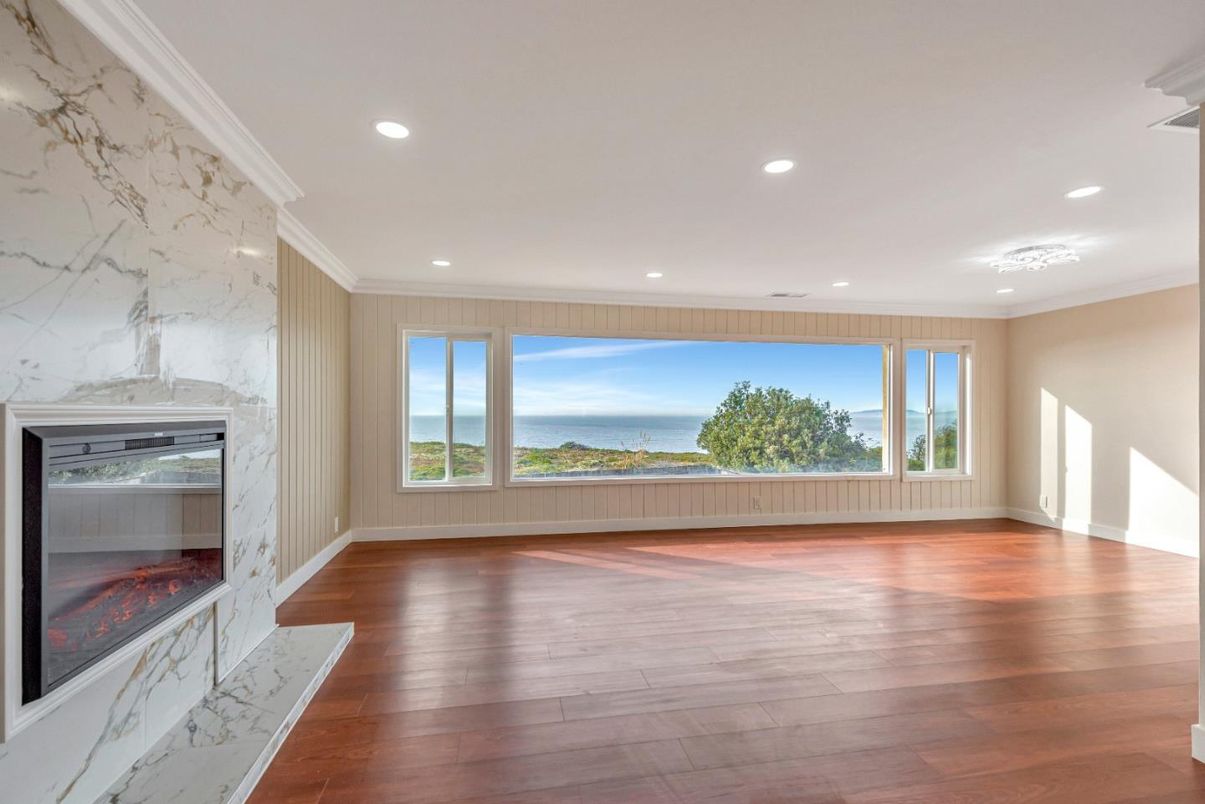 Empty room, Fireplace, Interior, Marble Walls, Recessed Lighting, Water, Wood Texture Flooring