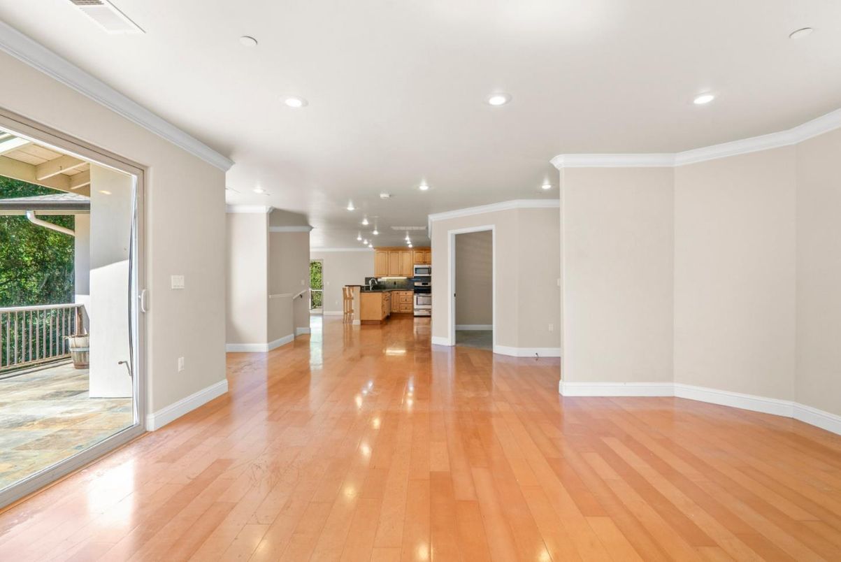 Empty room, Interior, Kitchen, Recessed Lighting, Stainless Steel Appliances, Wood Texture Flooring