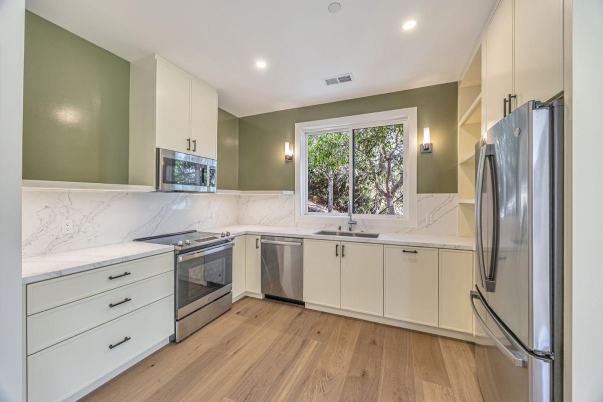 Interior, Kitchen, Marble Walls, Recessed Lighting, Stainless Steel Appliances, Wood Texture Flooring