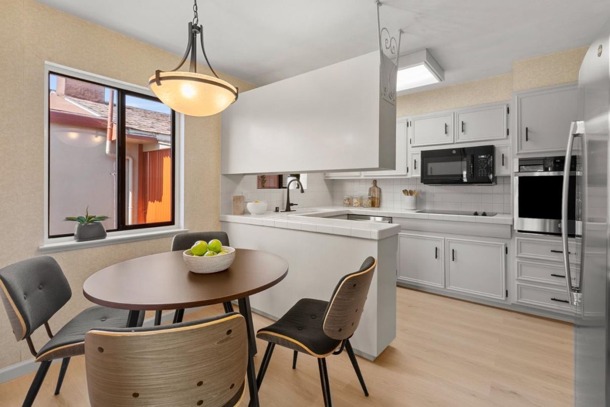 Dining room, Interior, Kitchen, Pendant Lights, Stainless Steel Appliances, Tile Countertops, Wood Texture Flooring