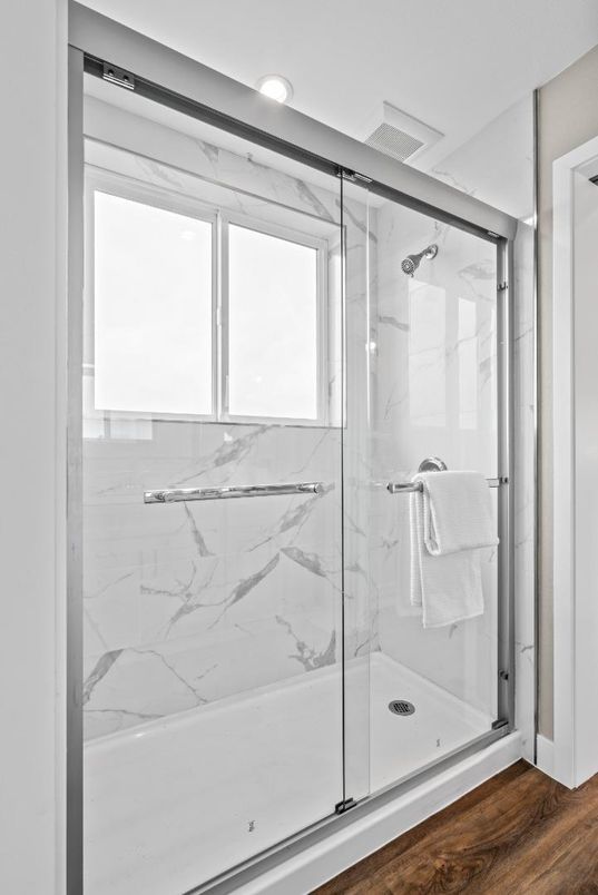 Bathroom, Glass Shower, Interior, Marble Walls, Recessed Lighting, Wood Texture Flooring