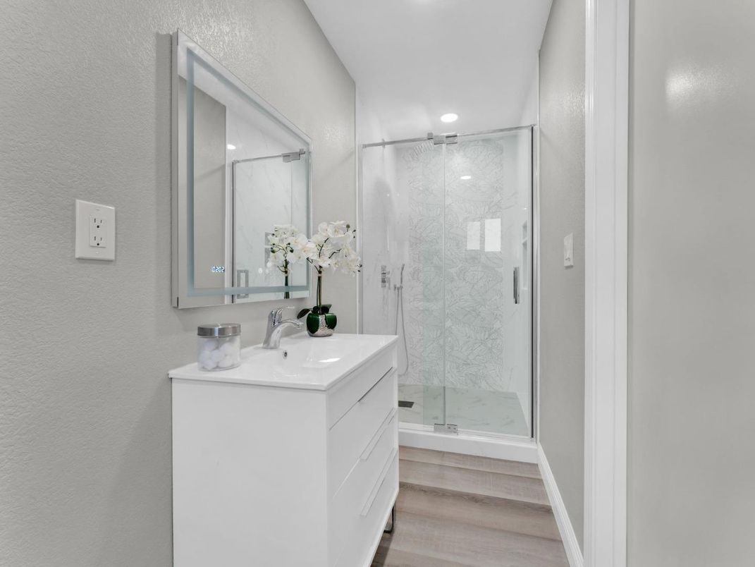 Bathroom, Glass Shower, Interior, Marble Walls, Recessed Lighting, Wood Texture Flooring