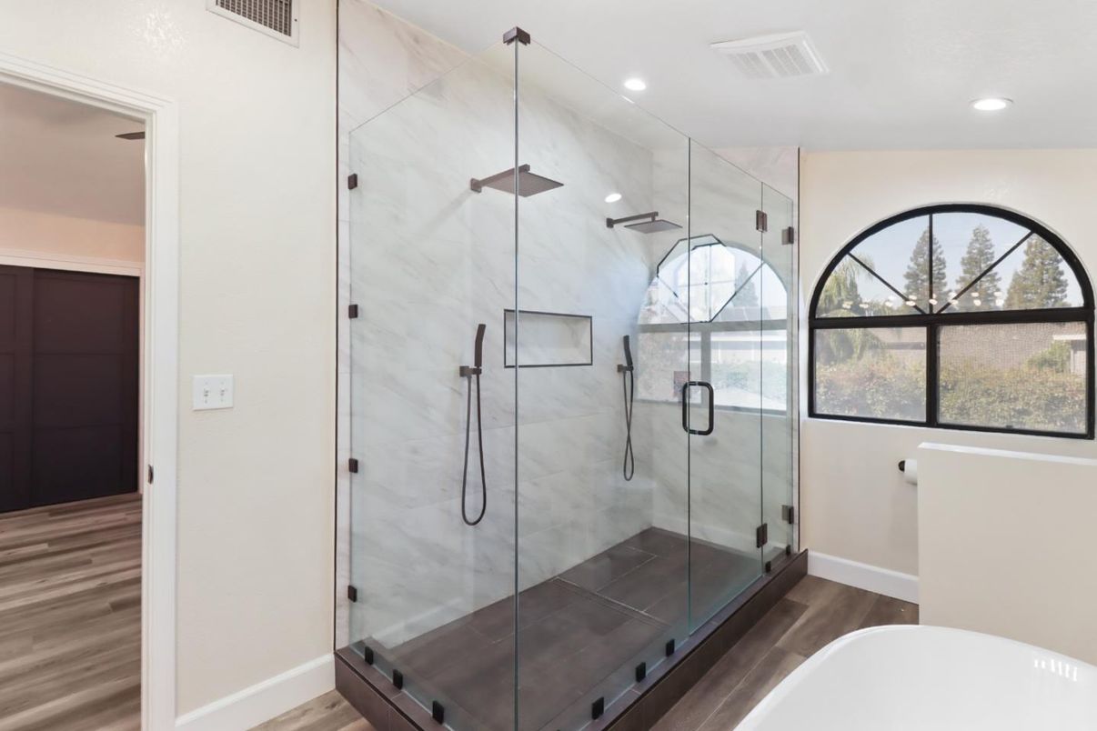 Bathroom, Free Standing Baths, Glass Shower, Interior, Marble Walls, Recessed Lighting, Wood Texture Flooring