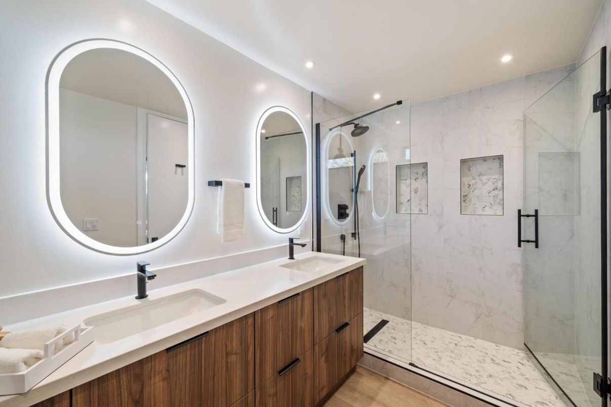 Bathroom, Dual Sink Vanities, Glass Shower, Interior, Marble Walls, Recessed Lighting, Wood Texture Flooring