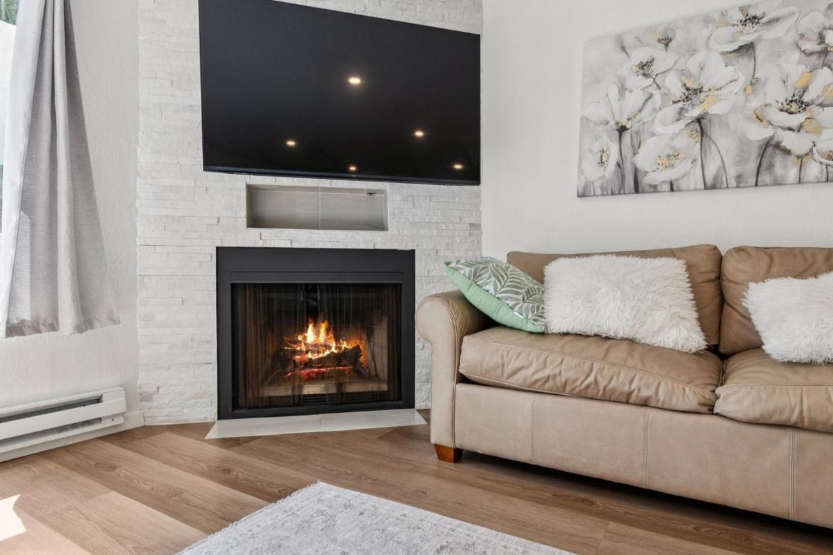 Fireplace, Interior, Living room, Recessed Lighting, Stone Walls, Wood Texture Flooring