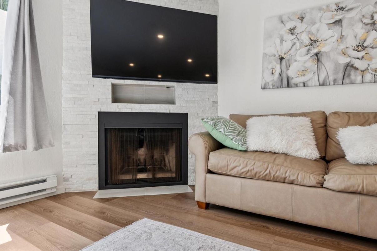 Fireplace, Interior, Living room, Recessed Lighting, Stone Walls, Wood Texture Flooring