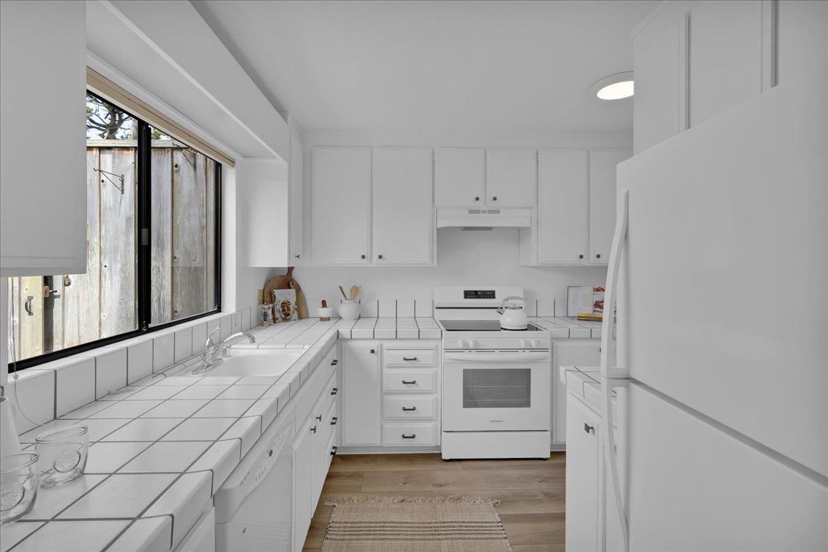 Interior, Kitchen, Recessed Lighting, Tile Countertops, Wood Texture Flooring