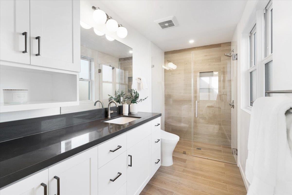Bathroom, Dual Sink Vanities, Glass Shower, Interior, Recessed Lighting, Wood Texture Flooring
