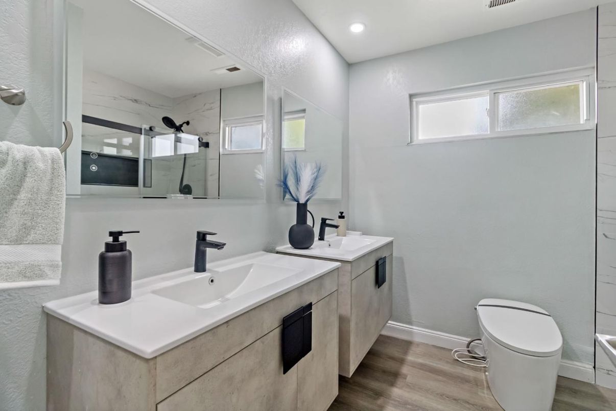 Bathroom, Dual Sink Vanities, Glass Shower, Interior, Marble Walls, Recessed Lighting, Wood Texture Flooring