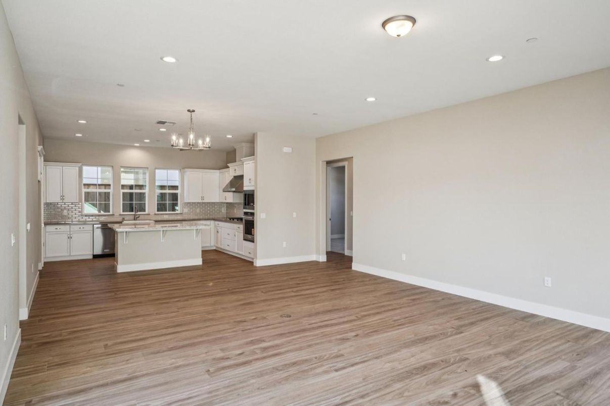 Empty room, Interior, Kitchen, Pendant Lights, Recessed Lighting, Stainless Steel Appliances, Wood Texture Flooring