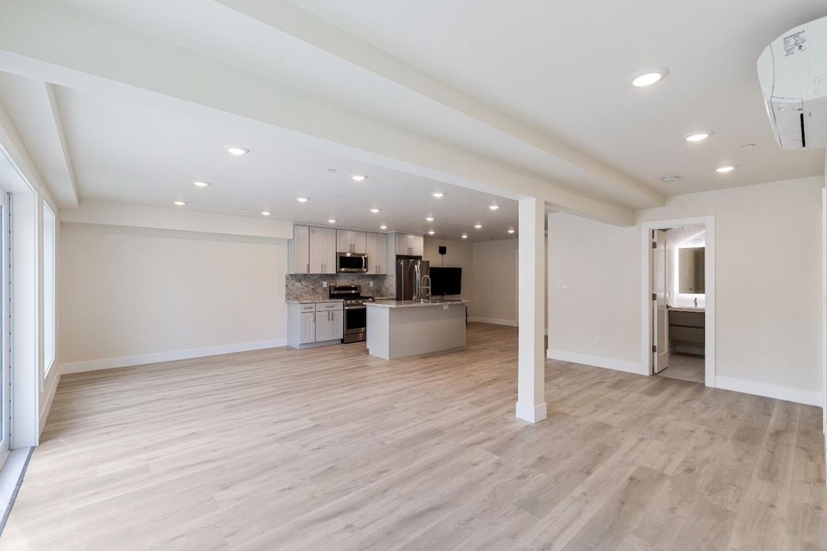 Empty room, Interior, Kitchen, Recessed Lighting, Stainless Steel Appliances, Wood Texture Flooring