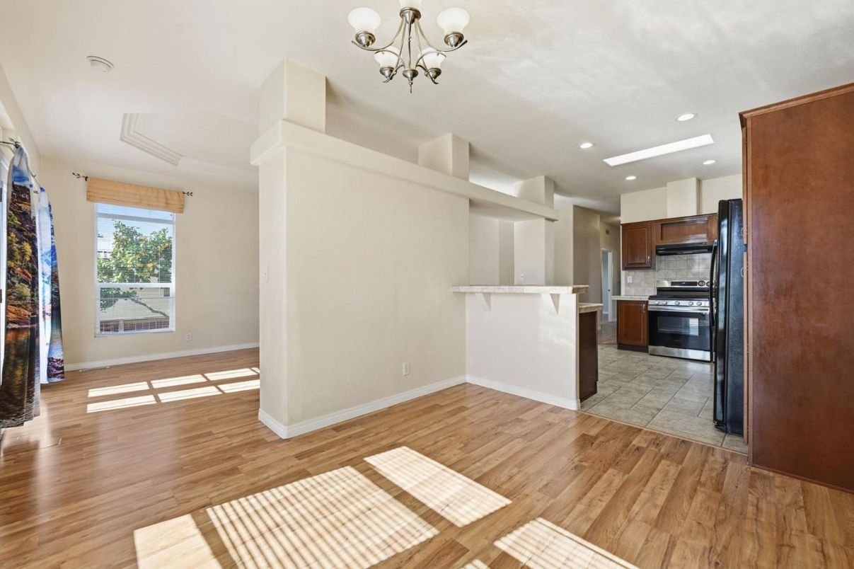 Chandelier, Empty room, Interior, Kitchen, Recessed Lighting, Stainless Steel Appliances, Wood Texture Flooring