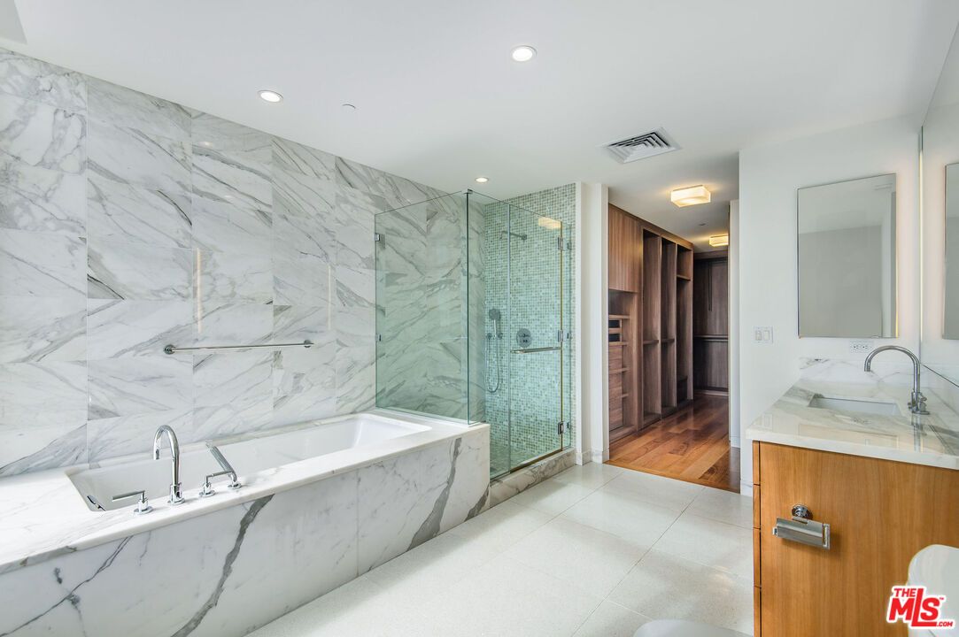 Bathroom, Dual Sink Vanities, Glass Shower, Interior, Marble Walls, Recessed Lighting, Wood Texture Flooring