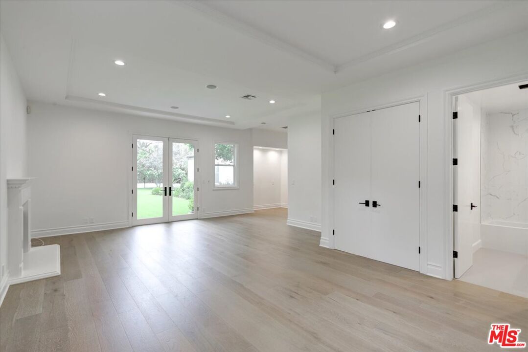 Empty room, Fireplace, Interior, Marble Walls, Recessed Lighting, Wood Texture Flooring