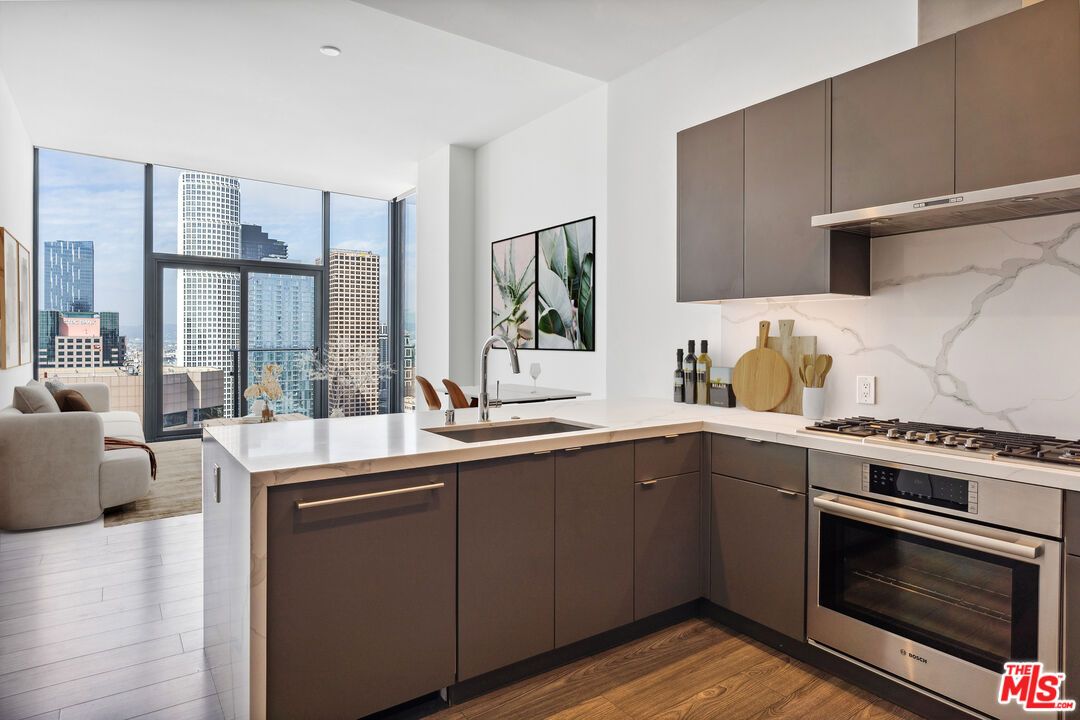 Interior, Kitchen, Marble Walls, Recessed Lighting, Stainless Steel Appliances, Wood Texture Flooring