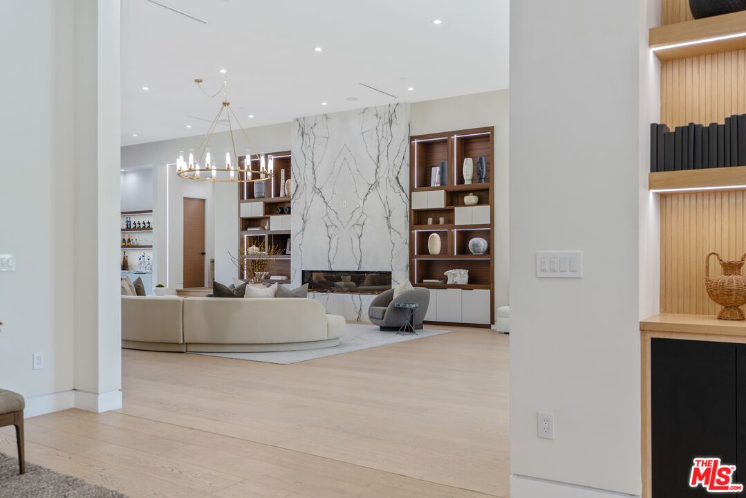 Chandelier, Fireplace, Interior, Living room, Marble Walls, Pendant Lights, Recessed Lighting, Wood Texture Flooring