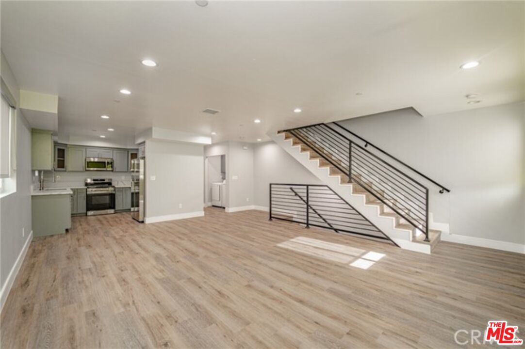 Empty room, Interior, Kitchen, Recessed Lighting, Stainless Steel Appliances, Wood Texture Flooring