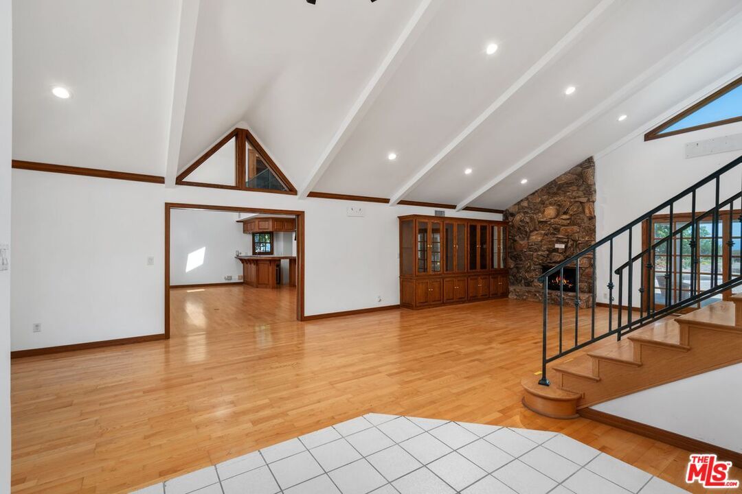 Empty room, Fireplace, Interior, Recessed Lighting, Stone Walls, Wood Texture Flooring