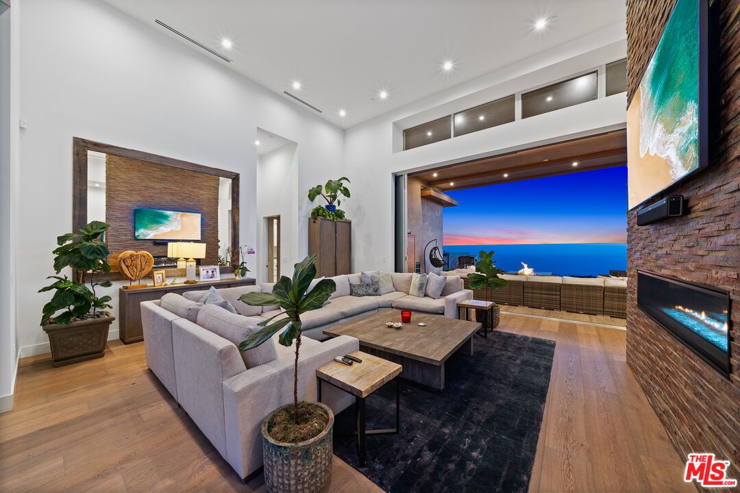Fireplace, Interior, Living room, Recessed Lighting, Stone Walls, Water, Wood Texture Flooring