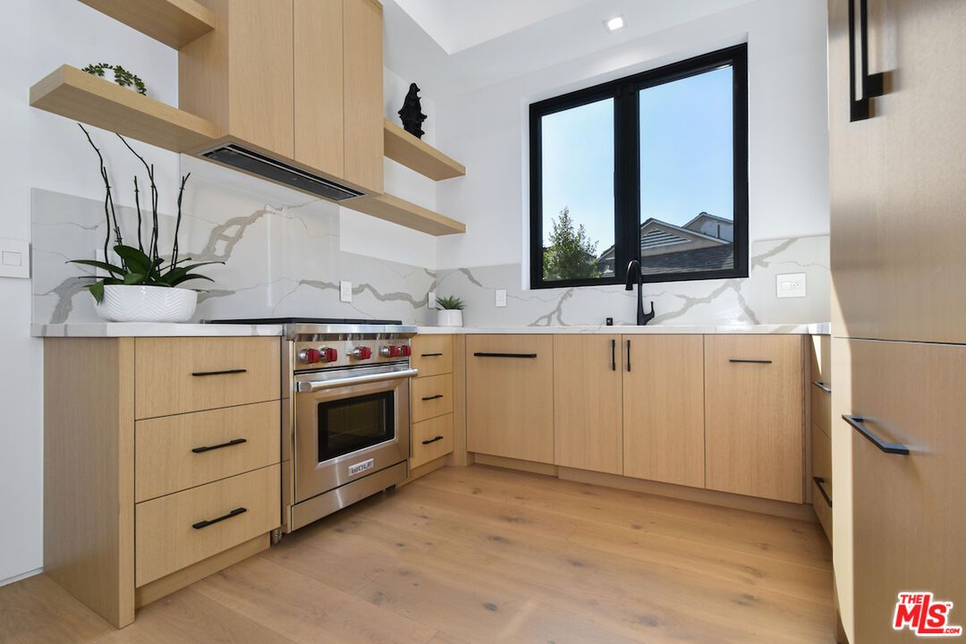 Interior, Kitchen, Marble Walls, Recessed Lighting, Stainless Steel Appliances, Wood Texture Flooring