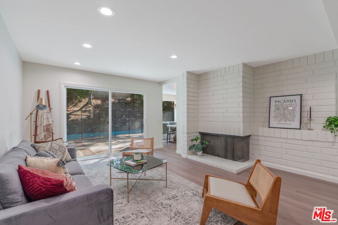 Fireplace, Interior, Living room, Recessed Lighting, Stone Walls, Wood Texture Flooring