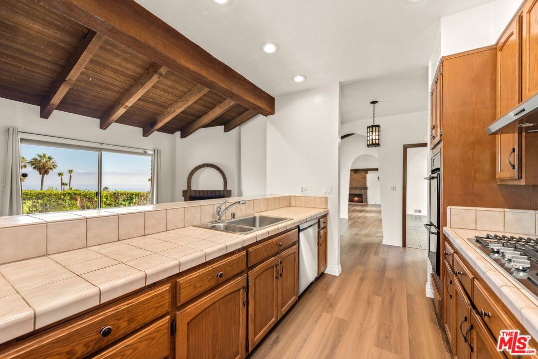 Interior, Kitchen, Pendant Lights, Recessed Lighting, Stainless Steel Appliances, Tile Countertops, Wooden Beams, Wooden Ceilings, Wood Texture Flooring