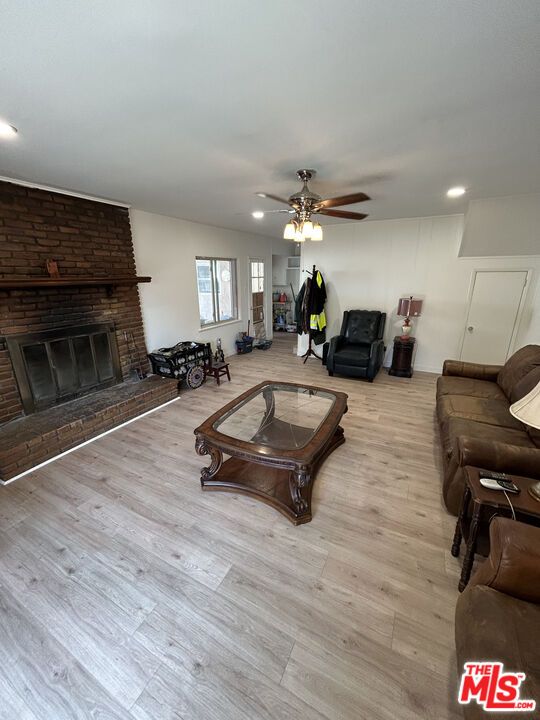 Fireplace, Interior, Living room, Recessed Lighting, Stone Walls, Wood Texture Flooring