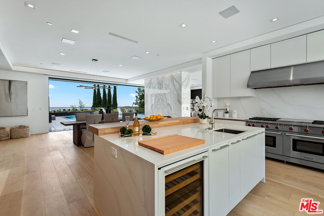 Dining room, Interior, Kitchen, Marble Walls, Pendant Lights, Recessed Lighting, Stainless Steel Appliances, Water, Wood Texture Flooring