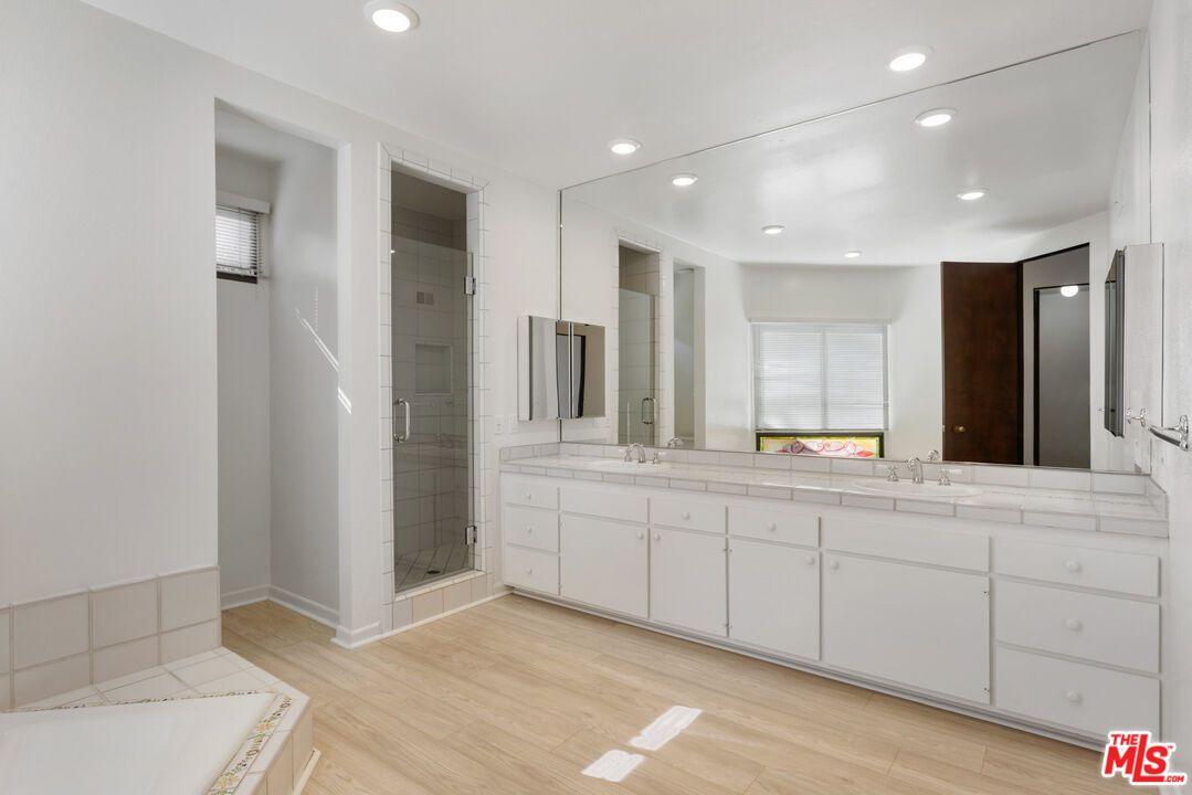 Bathroom, Dual Sink Vanities, Glass Shower, Interior, Recessed Lighting, Tile Countertops, Wood Texture Flooring