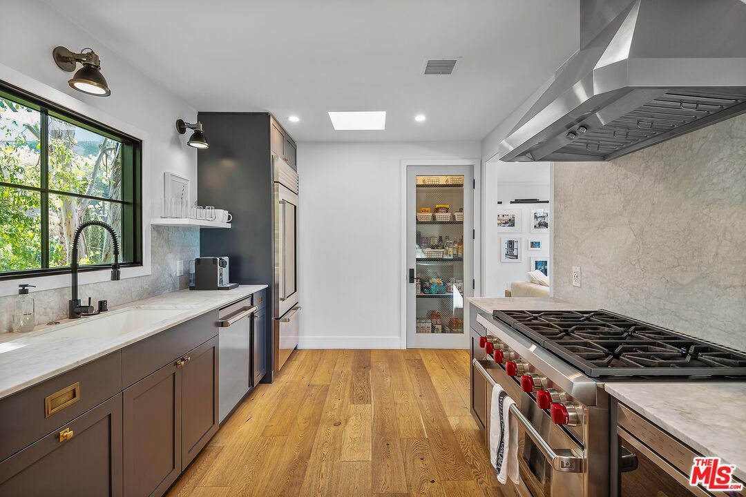 Interior, Kitchen, Marble Walls, Recessed Lighting, Stainless Steel Appliances, Wood Texture Flooring