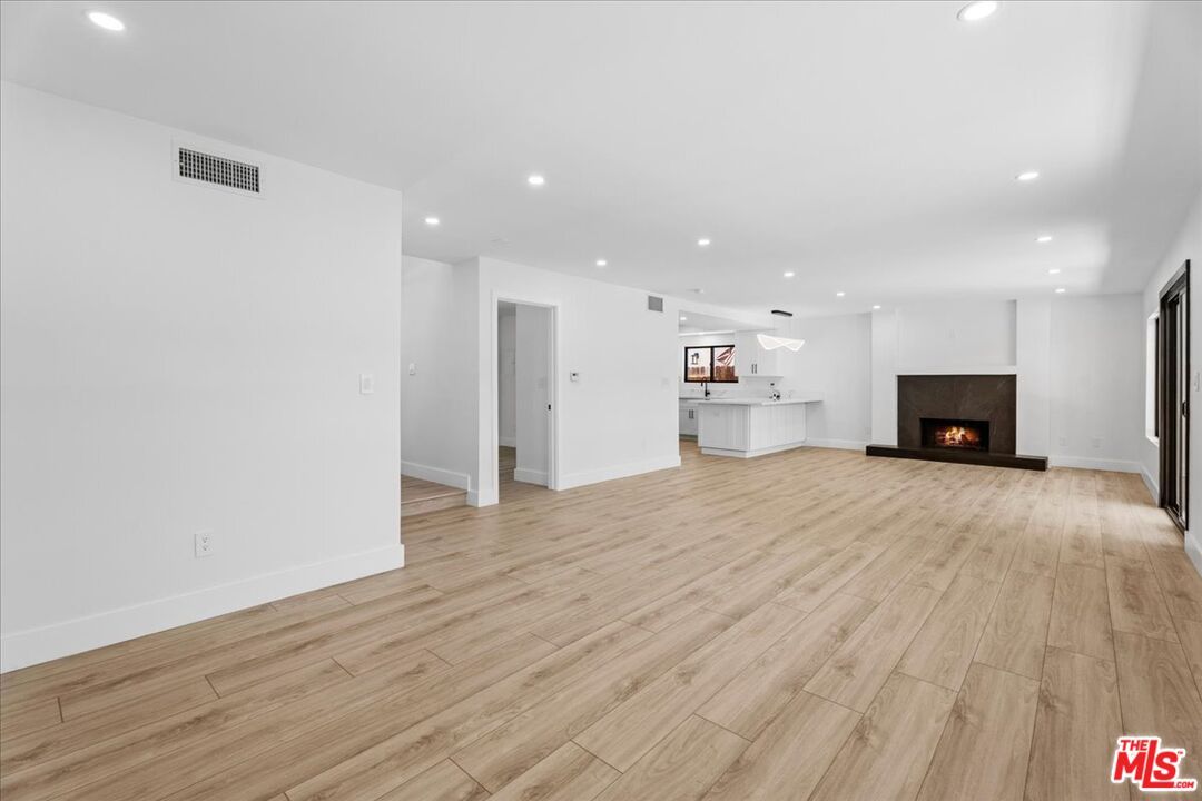Empty room, Fireplace, Interior, Kitchen, Pendant Lights, Recessed Lighting, Wood Texture Flooring