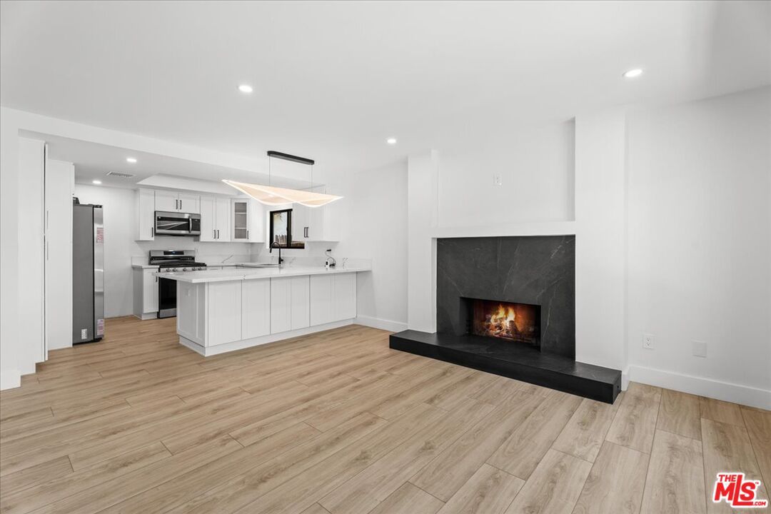 Fireplace, Interior, Kitchen, Pendant Lights, Recessed Lighting, Stainless Steel Appliances, Wood Texture Flooring
