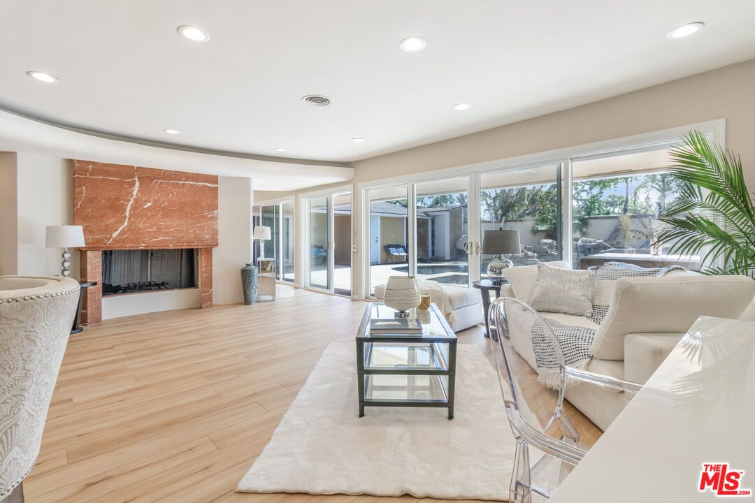 Fireplace, Interior, Living room, Marble Walls, Recessed Lighting, Wood Texture Flooring