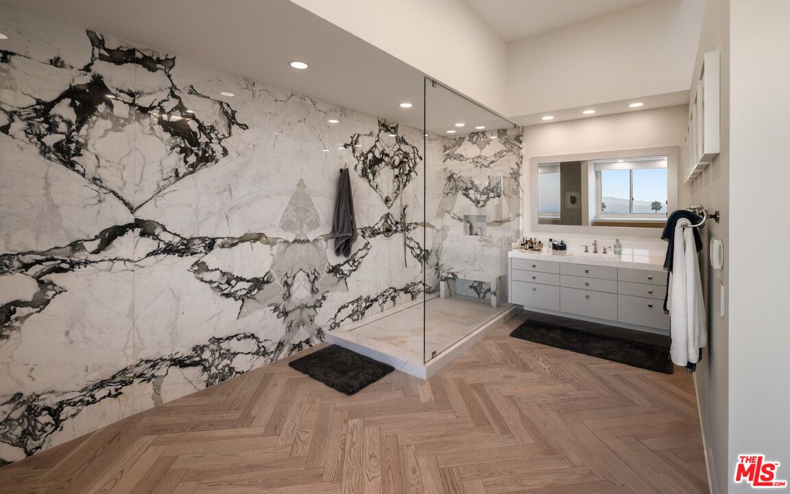 Bathroom, Dual Sink Vanities, Glass Shower, Interior, Marble Walls, Recessed Lighting, Wood Texture Flooring