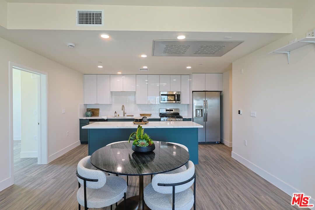 Dining room, Interior, Kitchen, Recessed Lighting, Stainless Steel Appliances, Wood Texture Flooring
