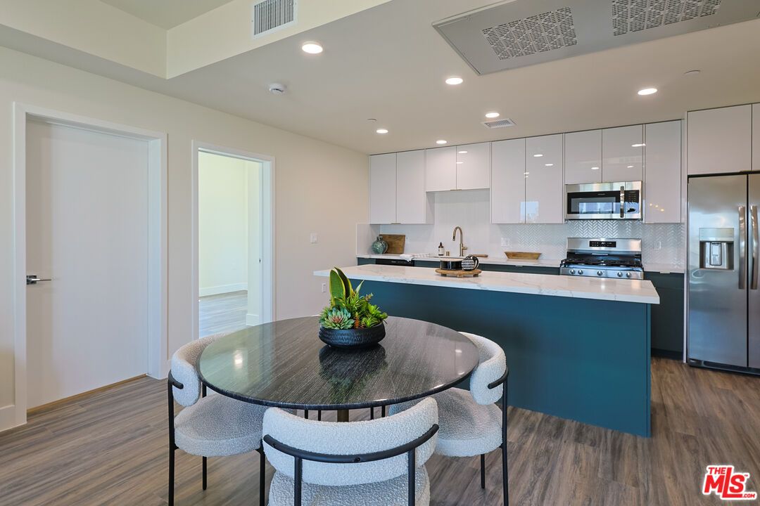 Dining room, Interior, Kitchen, Recessed Lighting, Stainless Steel Appliances, Wood Texture Flooring