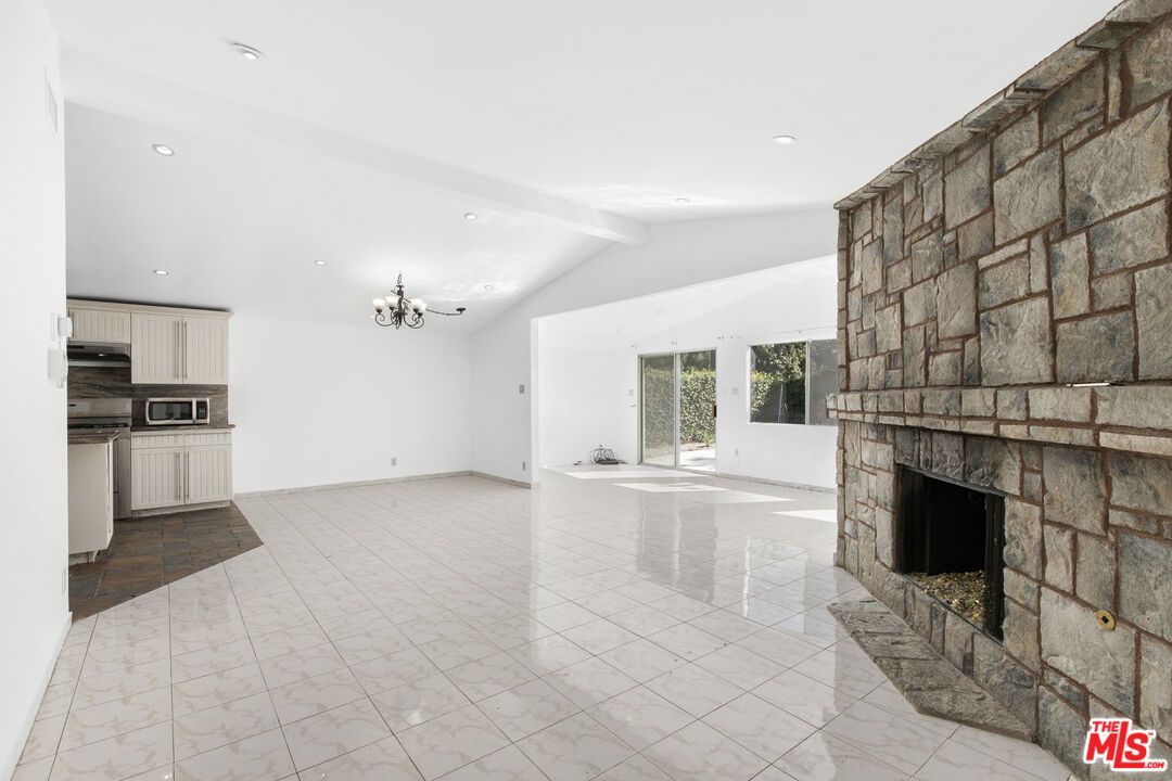 Chandelier, Empty room, Fireplace, Interior, Kitchen, Marble, Recessed Lighting, Stone Walls