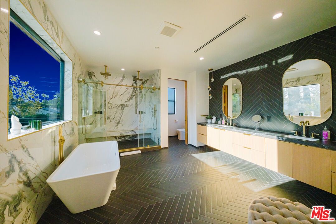 Bathroom, Dual Sink Vanities, Free Standing Baths, Glass Shower, Interior, Marble Walls, Recessed Lighting, Wood Texture Flooring
