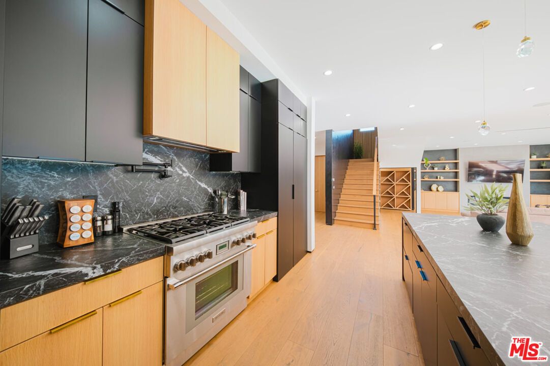 Interior, Kitchen, Marble Walls, Pendant Lights, Recessed Lighting, Stainless Steel Appliances, Wood Texture Flooring