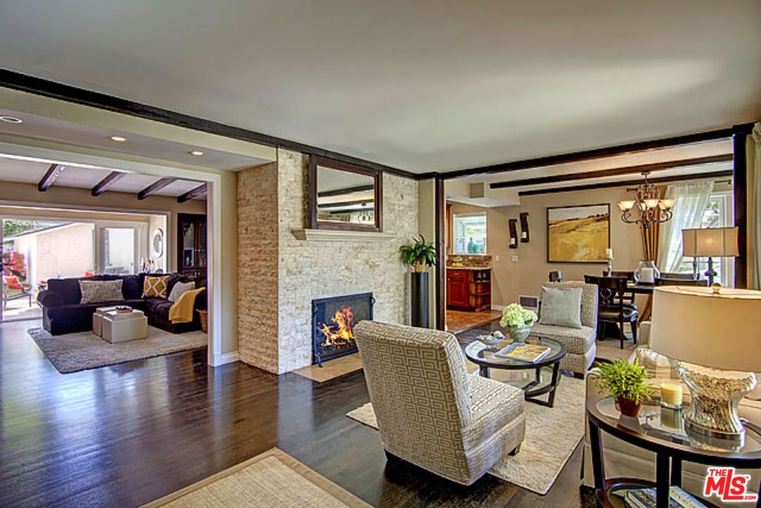 Chandelier, Dining room, Fireplace, Interior, Living room, Recessed Lighting, Stone Walls, Wooden Beams, Wood Texture Flooring