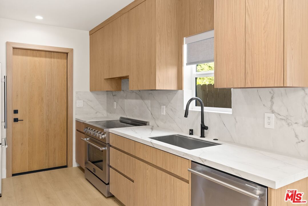 Interior, Kitchen, Marble Walls, Recessed Lighting, Stainless Steel Appliances, Wood Texture Flooring