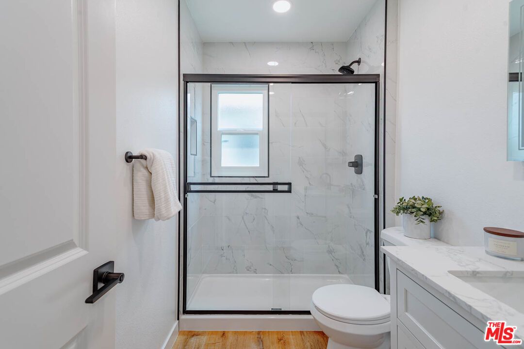 Bathroom, Glass Shower, Interior, Marble Walls, Recessed Lighting, Wood Texture Flooring