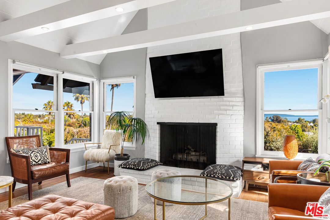 Fireplace, Interior, Living room, Recessed Lighting, Stone Walls, Water, Wood Texture Flooring