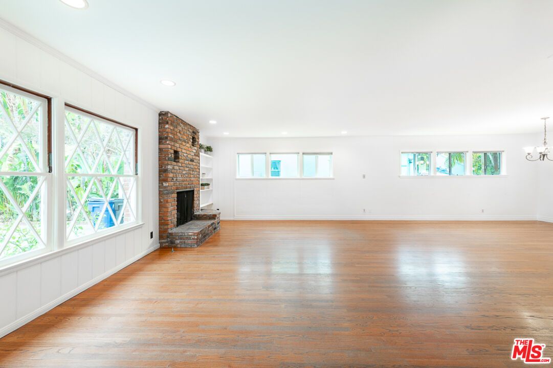Chandelier, Empty room, Fireplace, Interior, Recessed Lighting, Stone Walls, Wood Texture Flooring