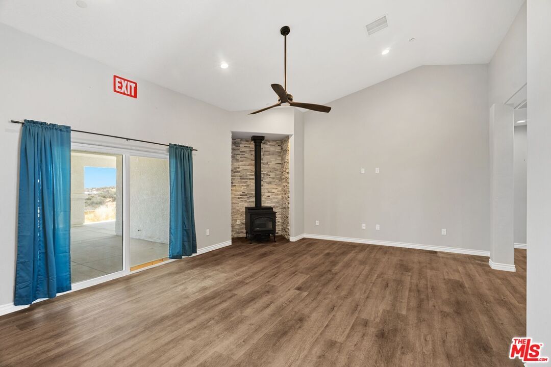Empty room, Fireplace, Interior, Recessed Lighting, Stone Walls, Wood Texture Flooring